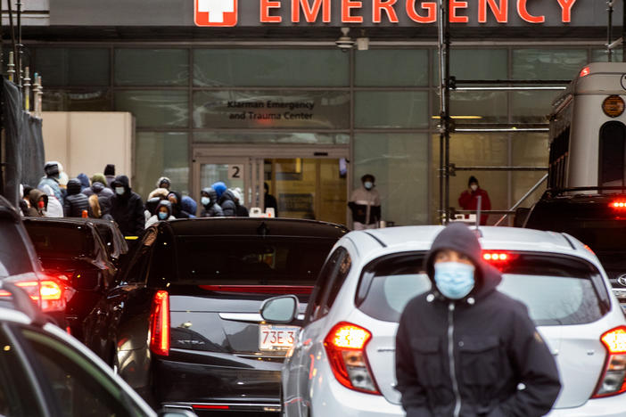People and cars line up outside Boston Medical Center near the emergency room, where COVID-19 testing was taking place, on Jan. 3.