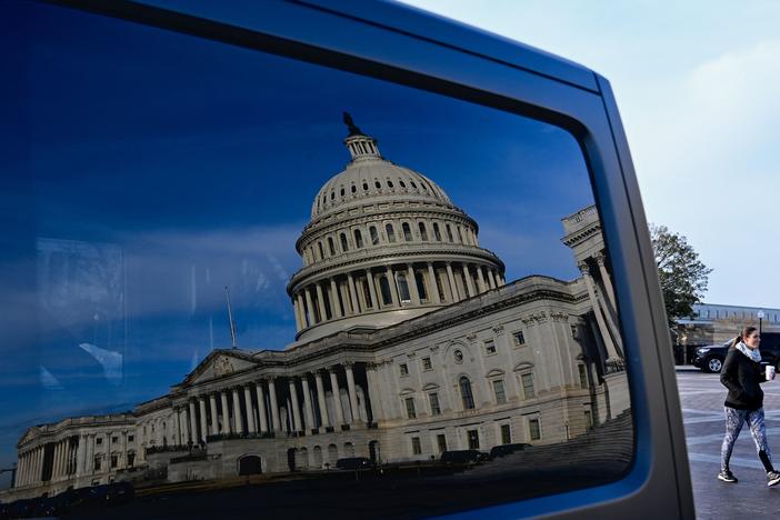 A reflection of the U.S. Capitol on a car window on Jan. 13, the day President Biden met with Senate Democrats to talk about voting rights legislation.