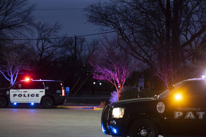 Police cars remain parked at Good Shepherd Catholic Community church on Saturday in Colleyville, Texas. Authorities said all hostages were freed safely.