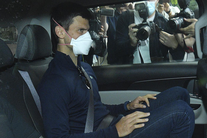 Serbian tennis player Novak Djokovic rides in car as he leaves a government detention facility before attending a court hearing at his lawyers office in Melbourne, Australia, on Jan. 16, 2022.