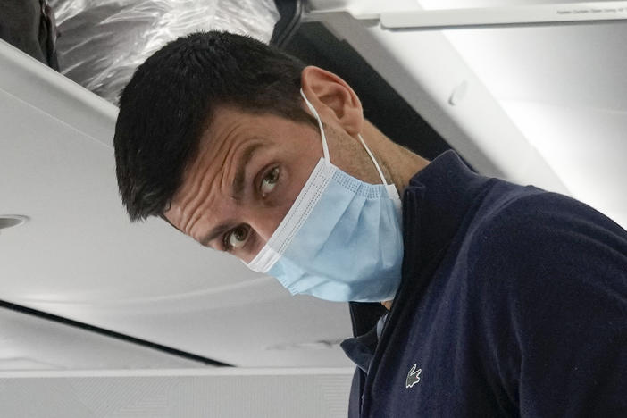 Novak Djokovic prepares to take his seat on a plane to Belgrade, in Dubai, United Arab Emirates, Monday, Jan. 17, 2022.