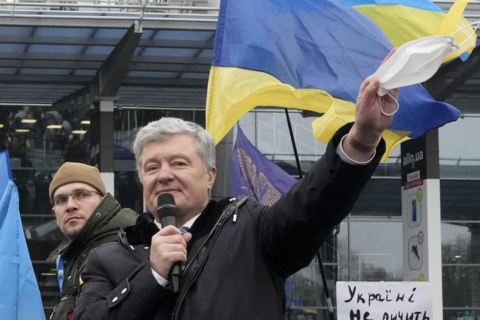 Former Ukrainian President Petro Poroshenko gestures while speaking to his supporters upon his arrival at Zhuliany International Airport outside Kyiv, Ukraine, Monday, Jan. 17, 2022.