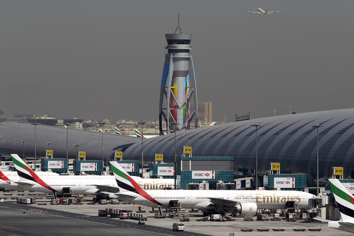 Emirates passenger planes are parked at their gates at Dubai International Airport in the United Arab Emirates.