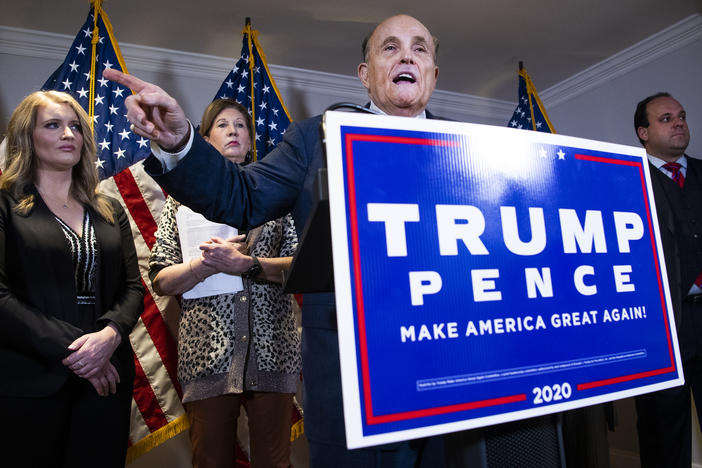 Rudy Giuliani, attorney for then-President Donald Trump, conducts a news conference at the Republican National Committee on lawsuits regarding the outcome of the 2020 presidential election on Nov. 19, 2020. Trump attorneys Jenna Ellis, far left, and Sydney Powell, second from left, and Boris Boris Epshteyn, right, also appear.