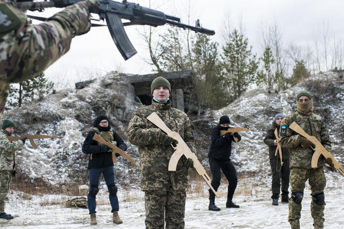 Members of Ukraine's Territorial Defense Forces take part in a Saturday morning training outside Kyiv. New members who have not yet trained with the unit must begin with the basics, and wooden mock weapons, regardless of their experience level.