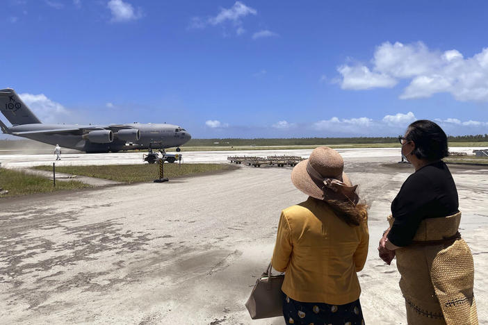 Tongan Foreign Minister Fekitamoeloa 'Utoikamanu (right) is accompanied by Australian High Commissioner to Tonga Rachael Moore as they receive a Royal Australian Air Force C-17A Globemaster III aircraft delivering Australian aid at Fuaʻamotu International Airport on Thursday.