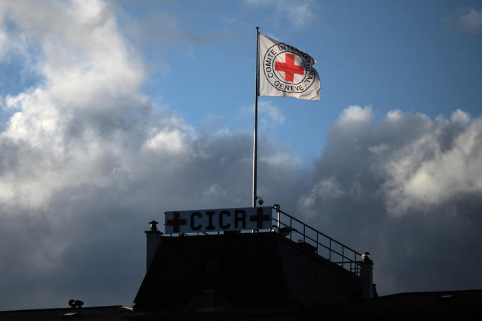 A flag of the International Committee of the Red Cross flutters above the humanitarian organization's headquarters in Geneva on Sept. 29, 2021. The ICRC is pleading with hackers to keep stolen data confidential.