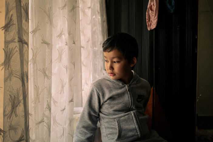 Lütfullah Kuçar, 8, waits at home for his sister, Aysu Kuçar, to return from school, in Istanbul. The two Uyghur children were forcibly separated from their family and spent nearly 20 months in state boarding schools in Xinjiang, China.