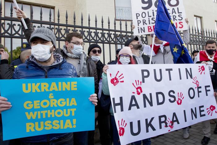 Georgian activists hold posters as they gather in support of Ukraine in front of the Ukrainian Embassy in Tbilisi, Georgia on Sunday, Jan. 23. The British government on Saturday accused Russia of seeking to replace Ukraine's government with a pro-Moscow administration.