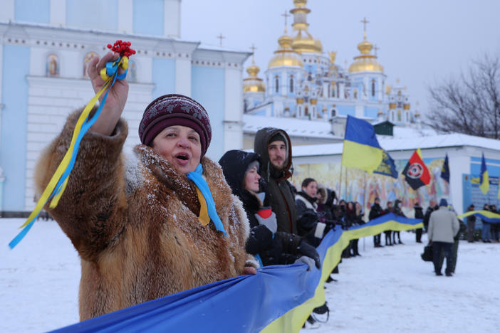 People rallying in patriotic support of Ukraine hold a 500 meter long ribbon in the colors of the Ukrainian flag outside St. Michael's Golden-Domed Monastery on Unity Day on Saturday in Kyiv, Ukraine.