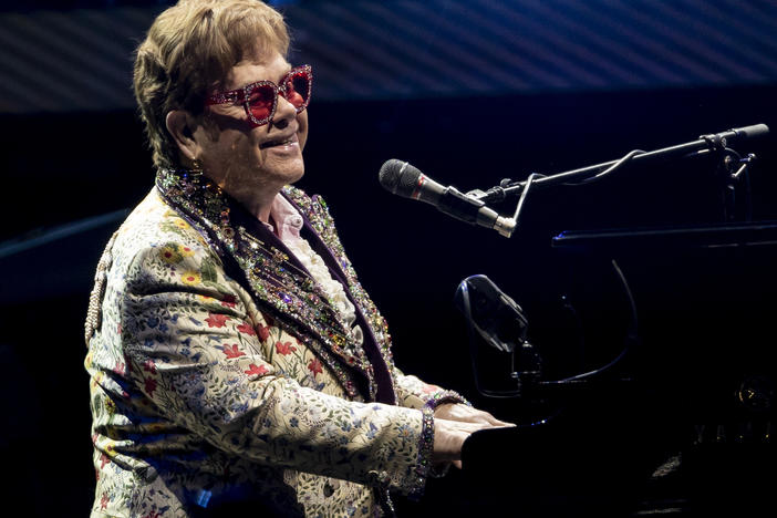 Elton John performs during his "Farewell Yellow Brick Road" tour on Jan. 19 in New Orleans. Despite being vaccinated and boosted, John has contracted COVID-19 and postponed two farewell concert dates in Dallas. John "is experiencing only mild symptoms," according to a statement.
