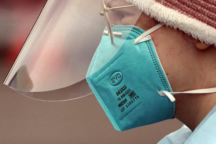 Linsey Jones, a medical assistant working at a drive-up coronavirus testing clinic, wears an N95 mask on Jan. 4 in Puyallup, Wash. The Biden administration will begin making 400 million N95 masks available for free to Americans starting this week.