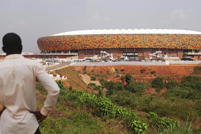A man standing outside a newly build Olembe stadium in Yaoundé, Cameroon, on Jan. 8, 2022. A crush outside the stadium on Monday has left at least six people dead.