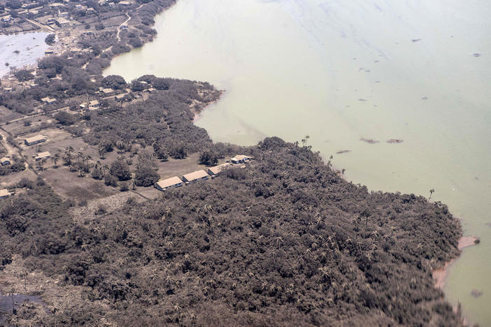 Volcanic ash covers rooftops and vegetation in an area of Tonga last week. Thick ash on an airport runway was delaying aid deliveries to the Pacific island nation, where significant damage was reported.