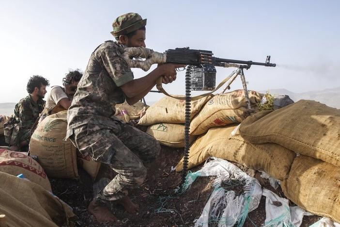 A Yemeni fighter backed by the Saudi-led coalition fires his weapon during clashes with Houthi rebels on the Kassara frontline near Marib, Yemen, Sunday, June 20, 2021.