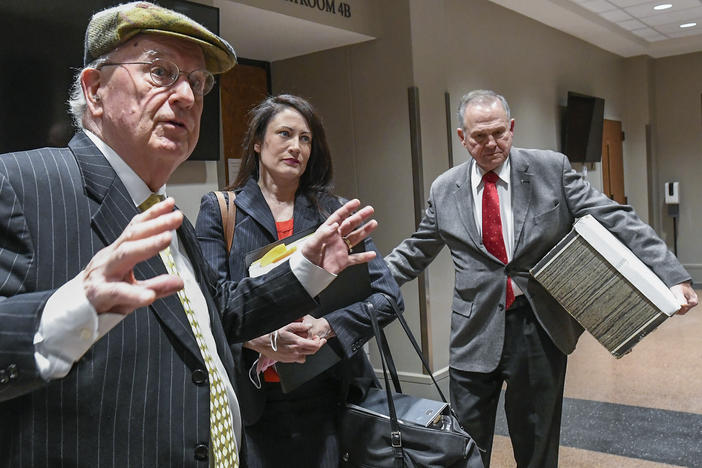 Former Alabama Chief Justice Roy Moore, right, and his attorney Julian McPhillips, left, leave the courtroom in Montgomery, Ala., on Monday following jury selection. Moore and Leigh Corfman, who accused him of sexual assault, are suing each other for defamation.