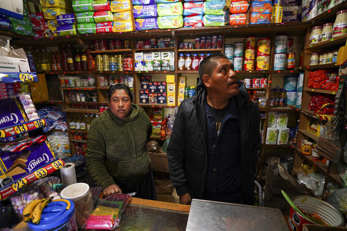 Jose Gonzalez and his wife Maria, wait for customers in their corner shop that he remodeled, stocked and extended with money he earned over a decade working in the United States, in the Purepecha Indigenous community of Comachuen, Michoacan state, Mexico, Wednesday, Jan. 19, 2022. (AP Photo/Fernando Llano)