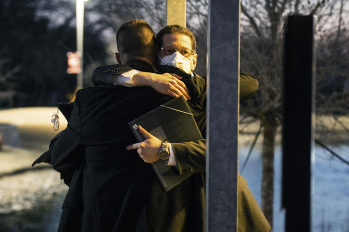 Congregation Beth Israel Rabbi Charlie Cytron-Walker, facing the camera, hugs a man after a healing service on Jan. 17, two days after he and three others were taken hostage at his Colleyville, Texas, synagogue.