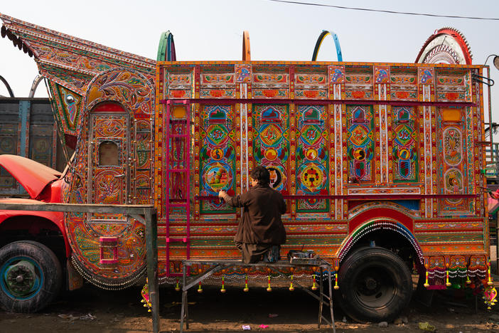 Painter Irfan Mohammad works on a truck at a sprawling workshop in Rawalpindi, Pakistan.