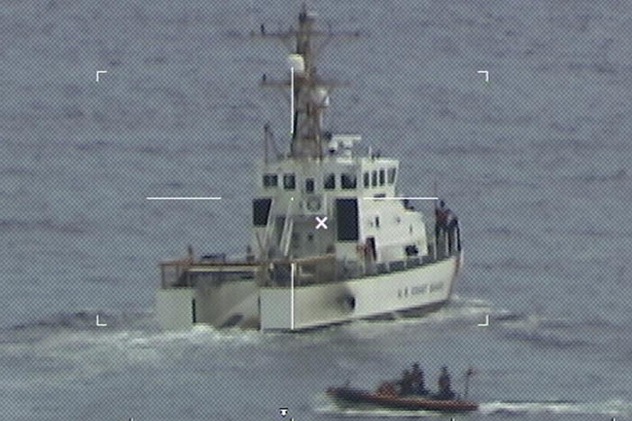 The crew of the Coast Guard Cutter Ibis' searches for people missing from a capsized boat off the coast of Florida on Tuesday.