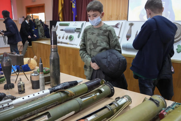 Schoolchildren look at explosives during a police-organized civilian safety lesson in a city school in Kyiv, Ukraine, on Thursday. City authorities have launched training for civilians amid fears about a Russian invasion.
