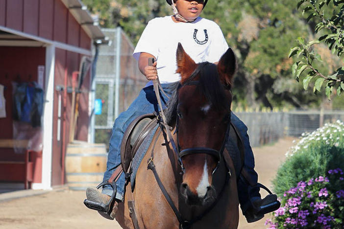 Jordan Humpreys seen riding his horse Winter at the Urban Saddles stables, in South Gate, Los Angeles.