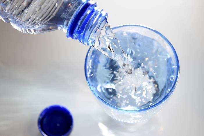 A glass is filled in with water on April 27, 2014 in Paris. Scientists studying what makes us thirsty have found the body checks in on our water consumption in several different ways.