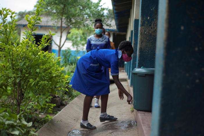 A student washes her hands before entering a classroom at a school in Blantyre, Malawi, in March 2021. Top scientists say that many African countries, including Malawi, appear to have already arrived at a substantially less threatening stage of the coronavirus pandemic.