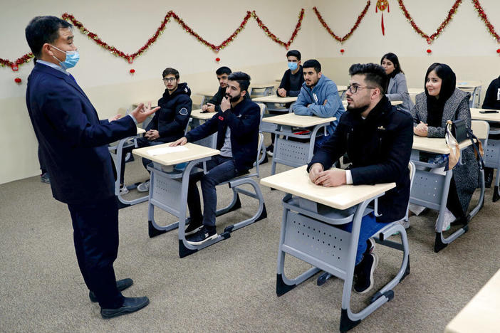 Chinese lecturer Zhiwei Hu speaks to students in the Chinese language department at Salahaddin University in Irbil, Iraq, Wednesday, Jan. 19, 2021.