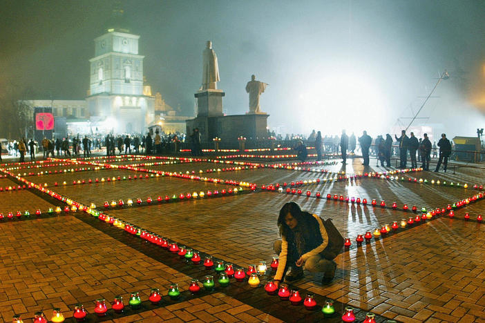 A woman lights a candle in Ukraine's capital, Kyiv, in 2006 as part of a remembrance of the estimated 3 million to 5 million Ukrainians who died in a famine in 1932-33. The Ukrainians starved to death when Soviet dictator Josef Stalin forced farmers from their land and into a collectivized, state-run agricultural system.