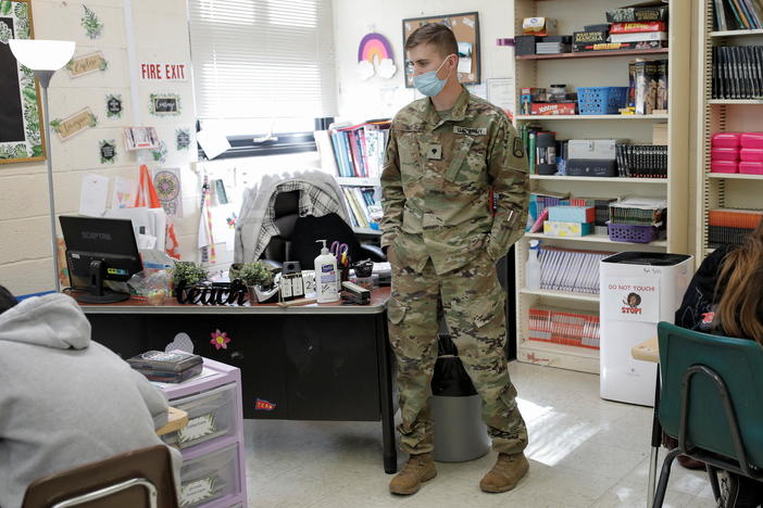 National Guard Specialist Austin Alt stands as he fills in as a substitute teacher due to staffing shortages caused by the coronavirus disease pandemic and other non-illness related absences at Pojoaque Valley Middle School in Pojoaque, N.M.