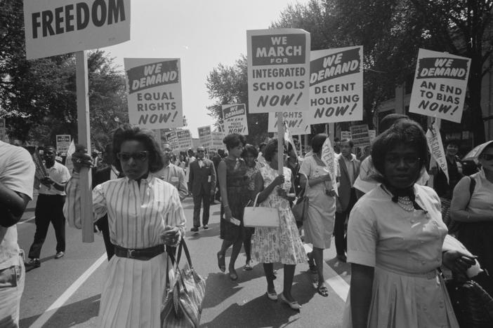 At the March on Washington on Aug. 28, 1963, African Americans carry placards demanding equal rights, integrated schools, decent housing and an end to bias.