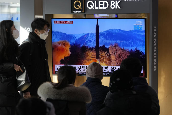 People watch a TV showing an image of North Korea's missile launch during a news program at the Seoul Railway Station in Seoul, South Korea on Monday, Jan 31.