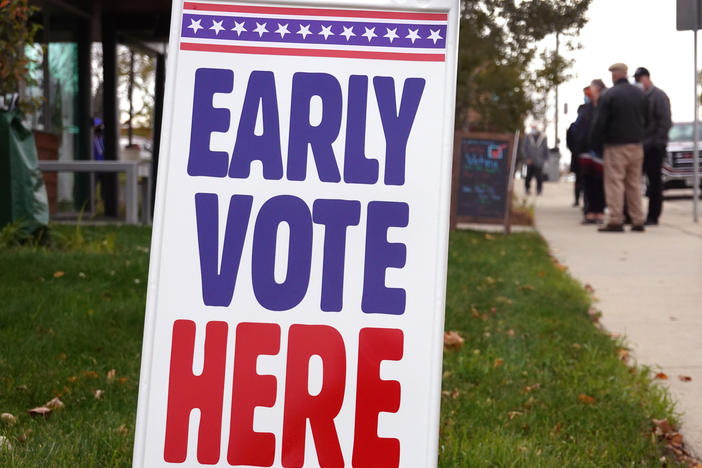 Residents wait in line to vote outside of the Tippecanoe branch library on Oct. 20, 2020, in Milwaukee, Wis. Minimum standards for access to in-person early voting are one reform that both Republicans and Democrats have backed.