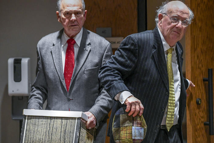 Former Alabama Chief Justice Roy Moore, left, and his attorney Julian McPhillips leave the courtroom in the Montgomery County Courthouse in Montgomery, Ala., on Jan. 24 following jury selection.