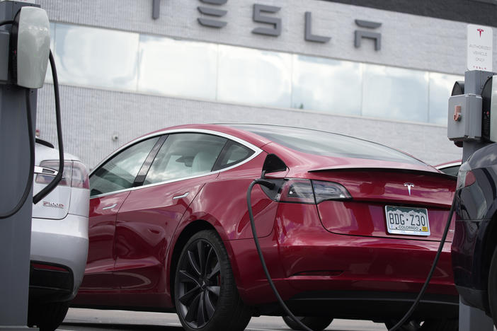 A 2021 Model 3 sedan sits in a lot at a Tesla dealership in Littleton, Colo., on June 27, 2021. Tesla is recalling nearly 54,000 vehicles because their "Full Self-Driving" software lets them roll through stop signs without coming to a complete halt.