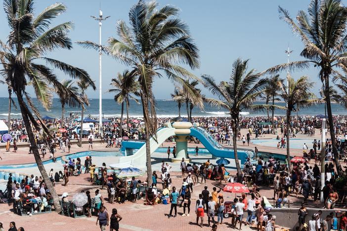 Thousands of New Year's day revelers gather on the South Beach in Durban after the government lifted a COVID-19 curfew.