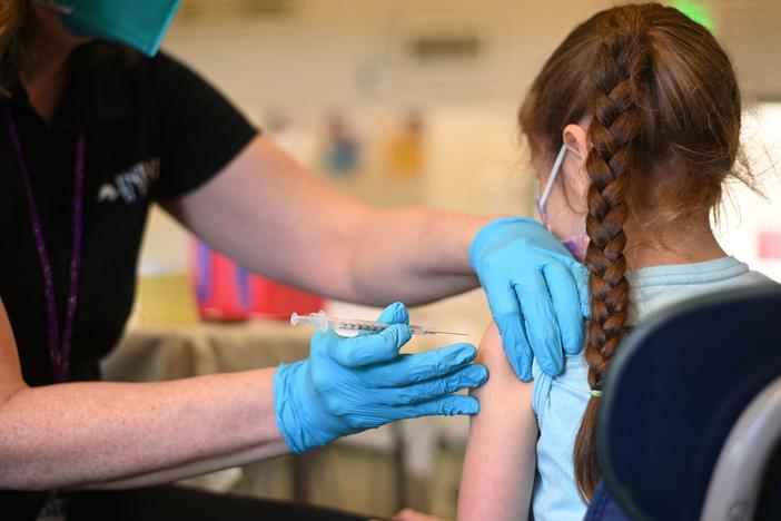 A nurse administers a pediatric dose of the Covid-19 vaccine to a girl at a L.A. Care Health Plan vaccination clinic at Los Angeles Mission College in the Sylmar neighborhood in Los Angeles, Ca., January 19, 2022.