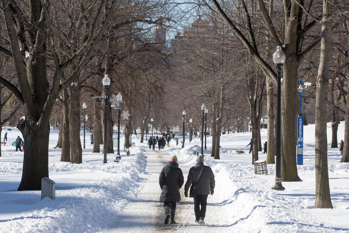 People walk on Boston Common in Boston after a snowstorm on Sunday. A powerful nor'easter last weekend brought blinding blizzard conditions with high winds causing widespread power outages to much of the Mid-Atlantic and New England coast. The storm dropped more than 30 inches in some areas of Massachusetts.