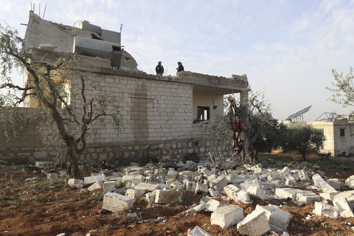 People check a destroyed house after a U.S. military operation in the Syrian village of Atmeh, in Idlib province, on Thursday. U.S. special forces carried out what the Pentagon said was a successful, large-scale counterterrorism raid. Local residents and activists said civilians were also among the dead.