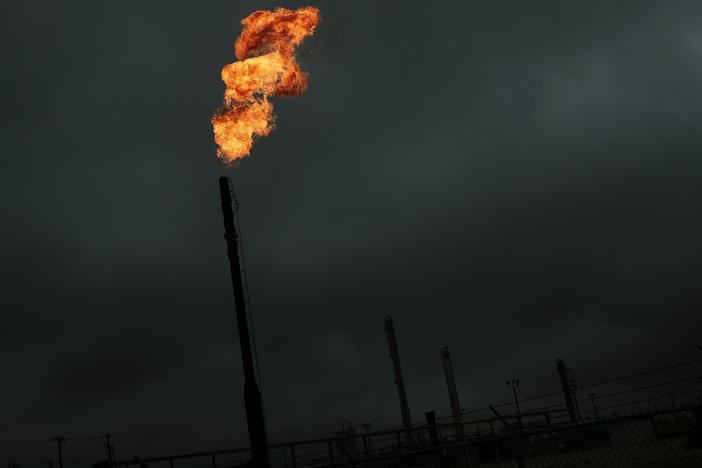 Flared natural gas is burned off at a natural gas plant. Methane, the main ingredient in natural gas, can leak from natural gas plants and pipelines.