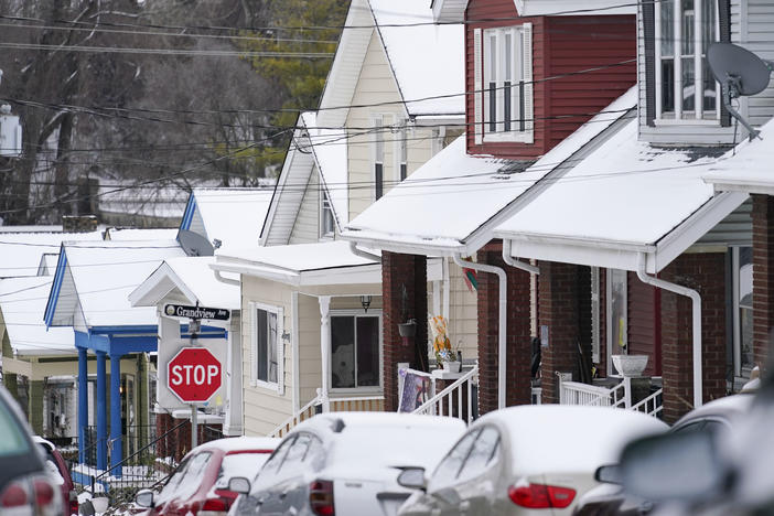 Snow blankets a row of homes after a snowstorm in Bellevue, Ky., on Friday.