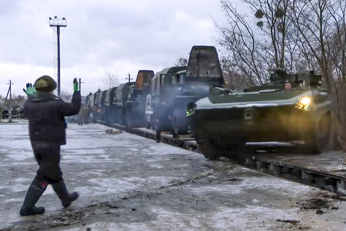 In this photo taken from video provided by the Russian Defense Ministry Press Service, a Russian armored vehicle drives off a railway platform after arrival in Belarus, Jan. 19, 2021. An estimated 100,000 Russian troops near Ukraine has fueled Western fears of an invasion, but Moscow has denied having plans to launch an attack while demanding security guarantees from the the U.S. and its allies.