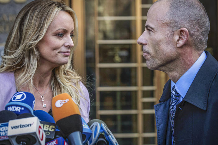 Adult film actress Stormy Daniels stands with her lawyer Michael Avenatti during a news conference outside federal court in New York on April 16, 2018. Avenatti was convicted Friday on charges that he cheated Daniels out of nearly $300,000.