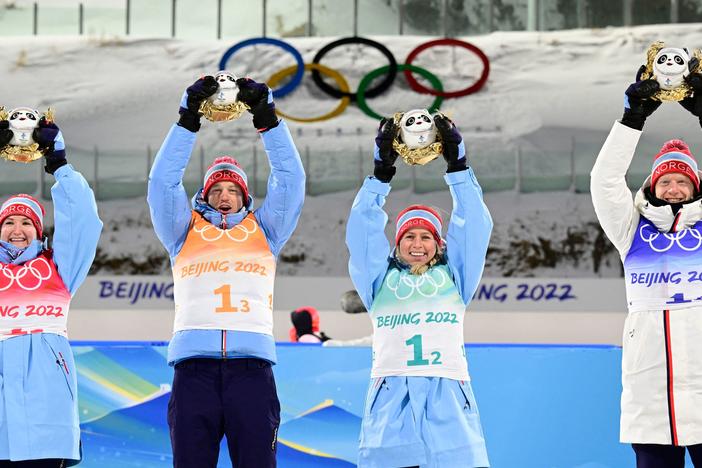 Norway's team, from left, Marte Olsbu Roeiseland, Tarjei Boe, Tiril Eckhoff and Johannes Thingnes Boe celebrate their first place finish during the medal ceremony in the Biathlon Mixed Relay 4x6km event on Feb. 5, 2022 at the Beijing Olympics.