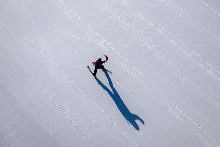 A skier takes a selfie on a course covered with artificial snow at the Yanqing National Alpine Skiing Centre in Yanqing.