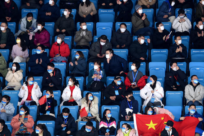 Spectators watch the men's single skating short program on Tuesday at the Winter Olympics in Beijing.