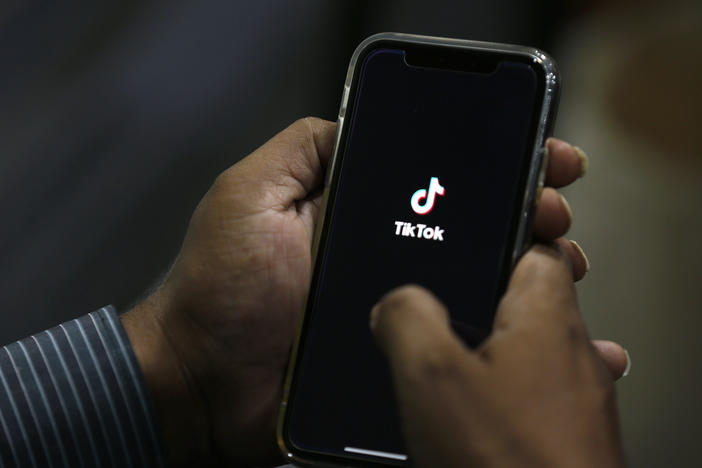 In this July 21, 2020 file photo, a man opens social media app 'TikTok' on his cell phone.