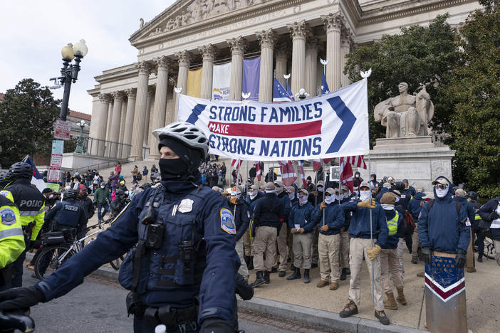 Members of the white supremacist group Patriot Front march on Constitution Avenue near the National Archives in Washington, Friday, Jan. 21, 2022.