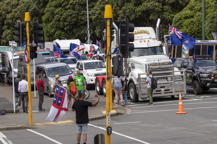 A convoy of vehicles block an intersection near New Zealand's Parliament in Wellington on Tuesday. Hundreds of people protesting vaccine and mask mandates drove in convoy to New Zealand's capital and converged outside Parliament as lawmakers reconvened after a summer break.